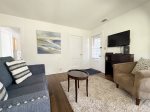 The living room has a smart TV and a sofa sleeper
